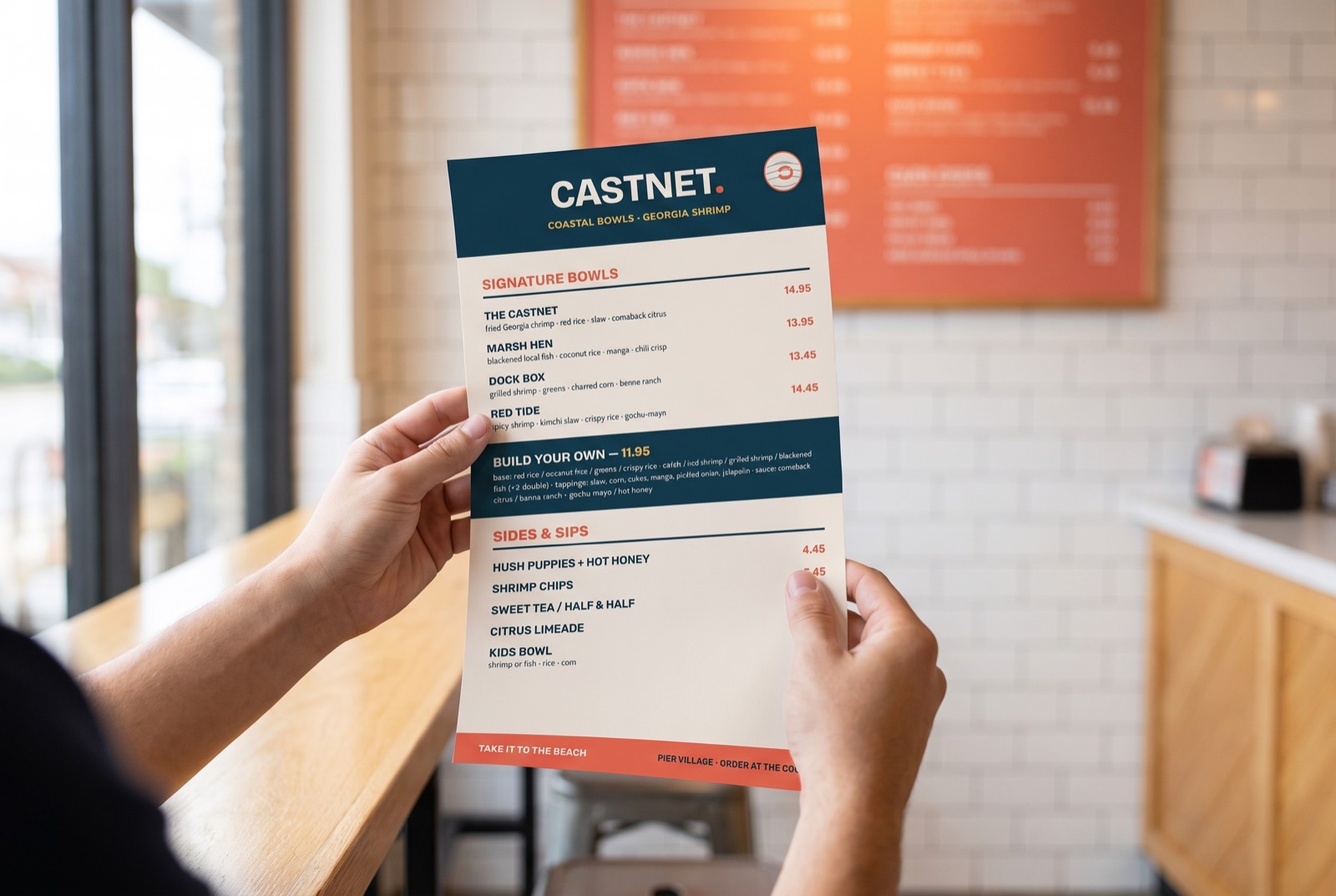 Hands holding the printed Castnet takeout menu inside the restaurant