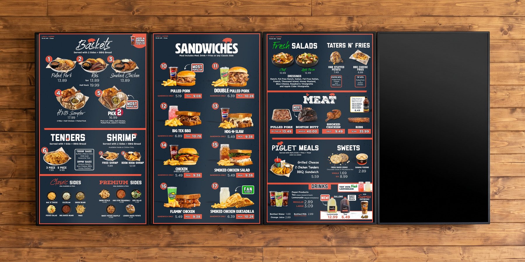 Four vertical digital menu panels on a wood plank wall showing the Hog-N-Bones lunch and supper menu system, with a rolling promo screen
